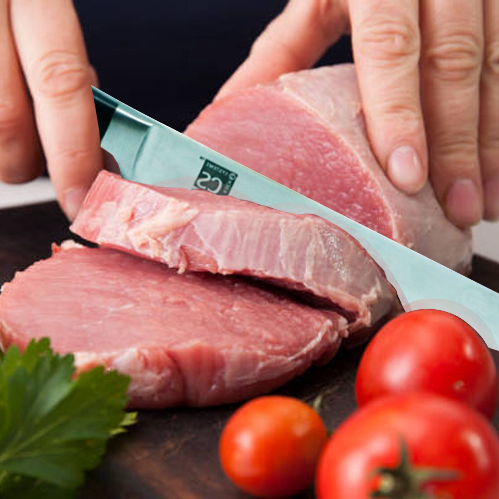 Woman cuts piece of fresh raw meat on wooden cutting board